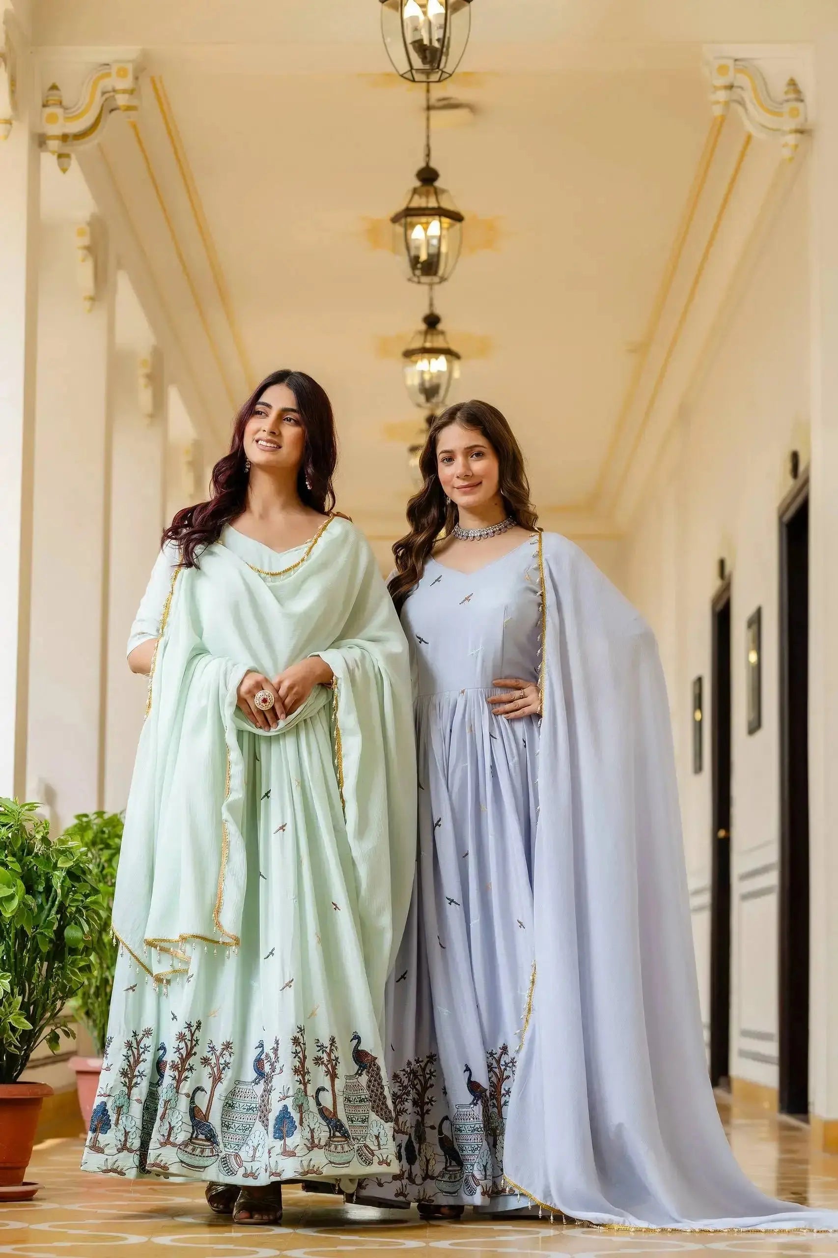 Two models in Chinon Anarkali Suits with peacock border – Kalyanja